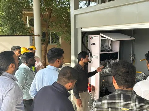 Engineer demonstrating the dispensing cabinet and fuel-management equipment to visitors