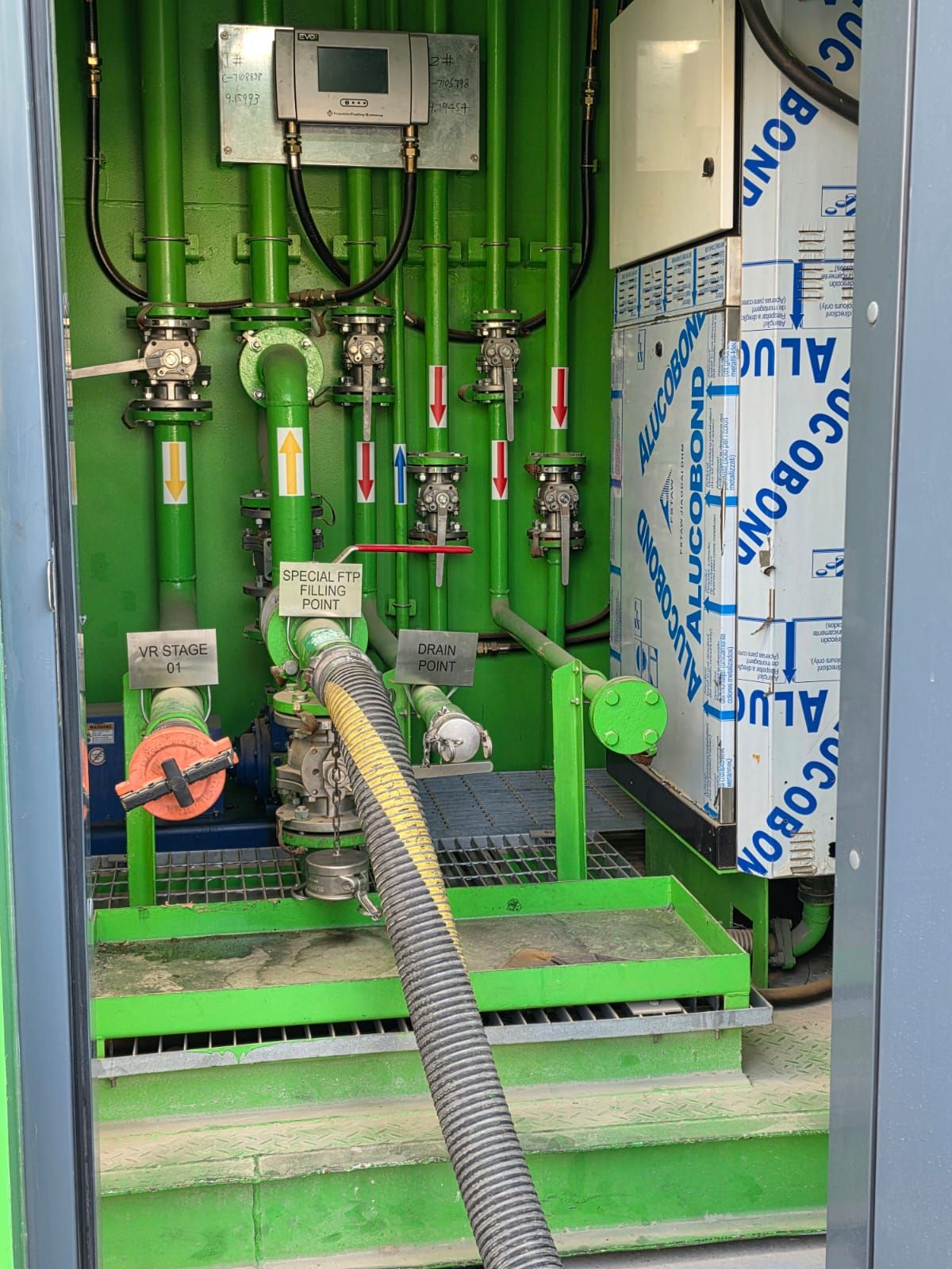 Product filling hose connected at the fill point inside the equipment cabinet
