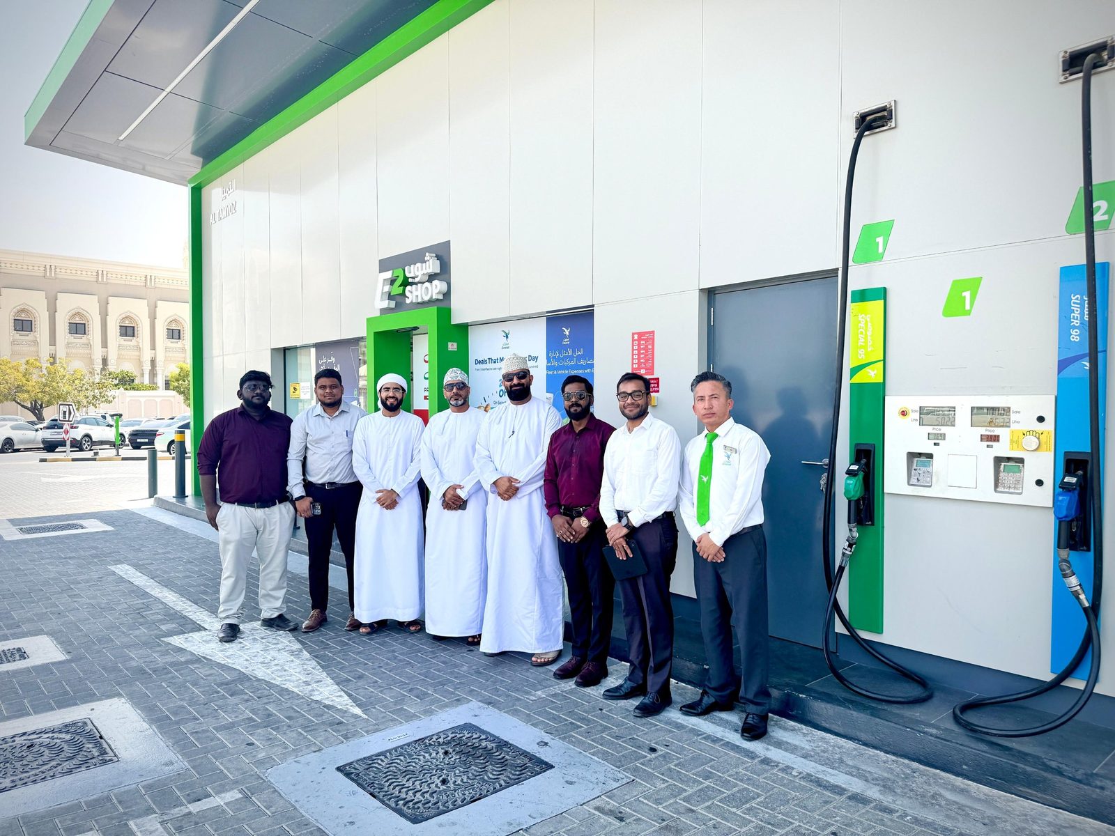 Visiting delegation and project team outside the shop at an Emarat service station