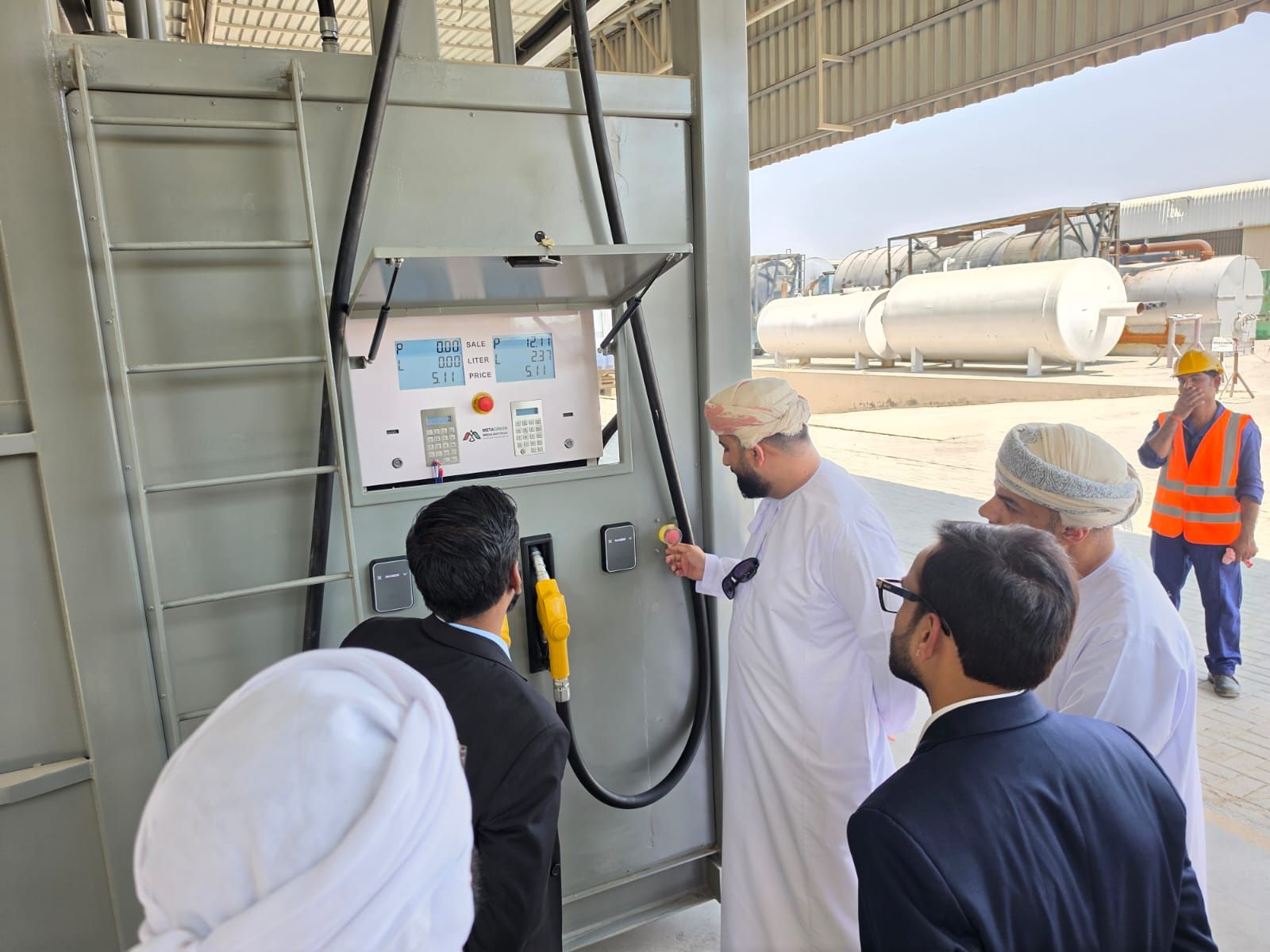Visitors examining the dispenser and nozzle on the side of the demo unit