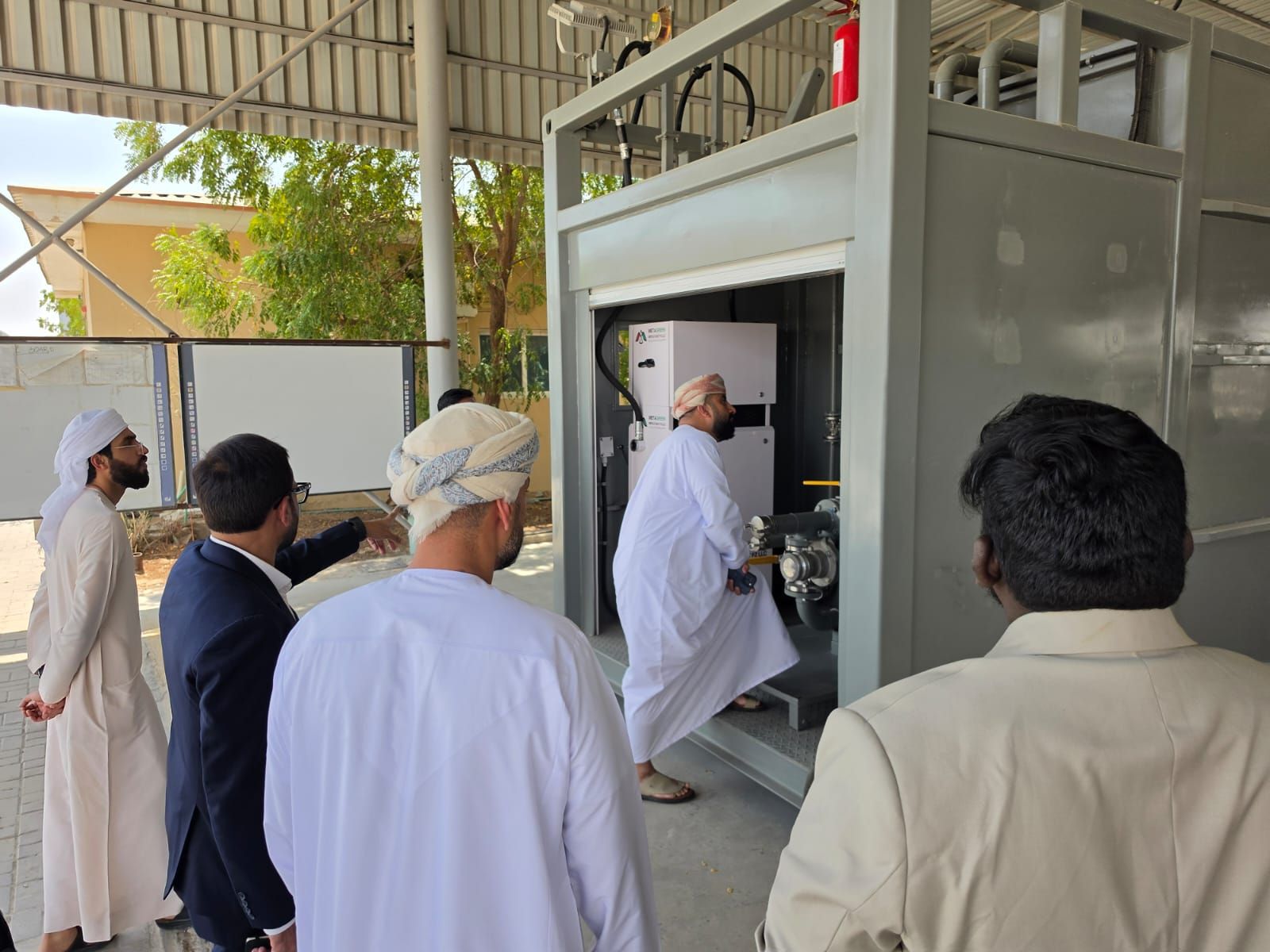 Visitors inspecting the equipment bay of the demo unit